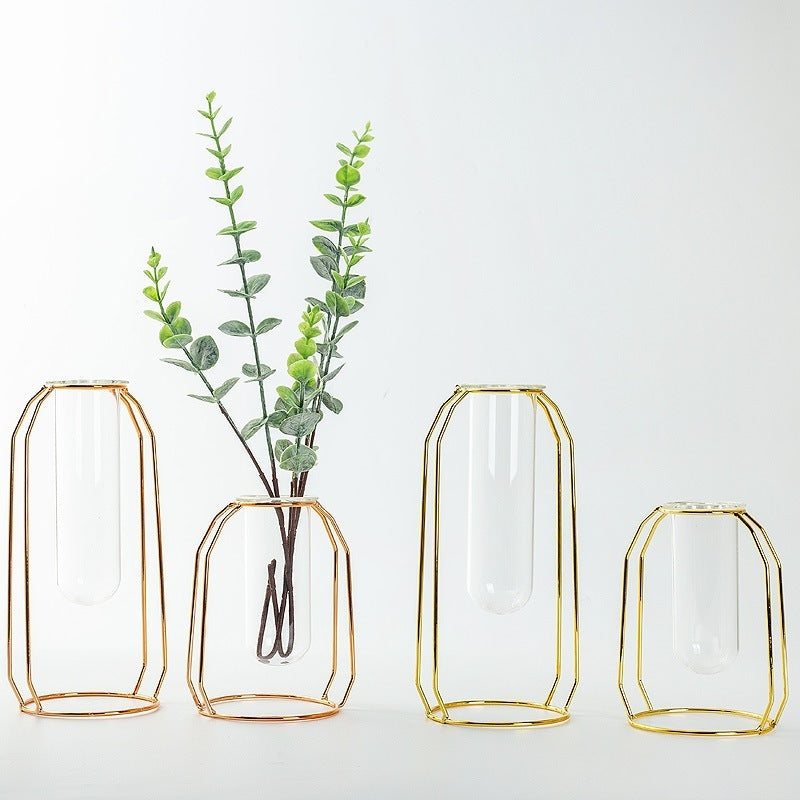 Set of modern Nordic geometric vases with clear glass vessels and gold and rose gold wrought iron frames, suitable for hydroponic plants and floral arrangements.