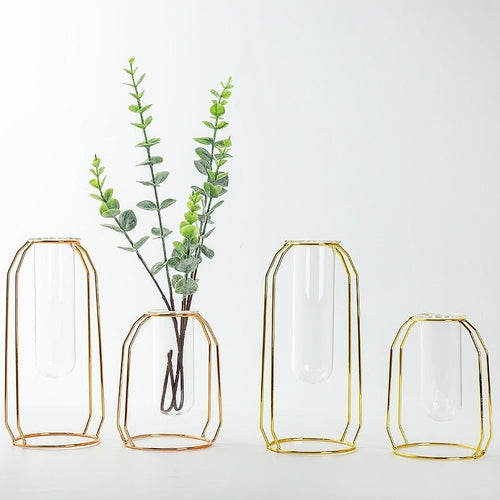 Set of modern Nordic geometric vases with clear glass vessels and gold and rose gold wrought iron frames, suitable for hydroponic plants and floral arrangements.